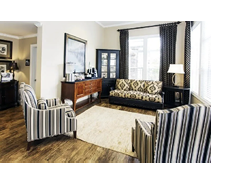 A living room with a couch, chair, and coffee table. A lamp is on the table. AI generated content